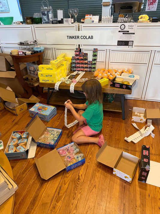 The girls helping unpack, label, and organize a Tinker Squish Lab delivery at the shop